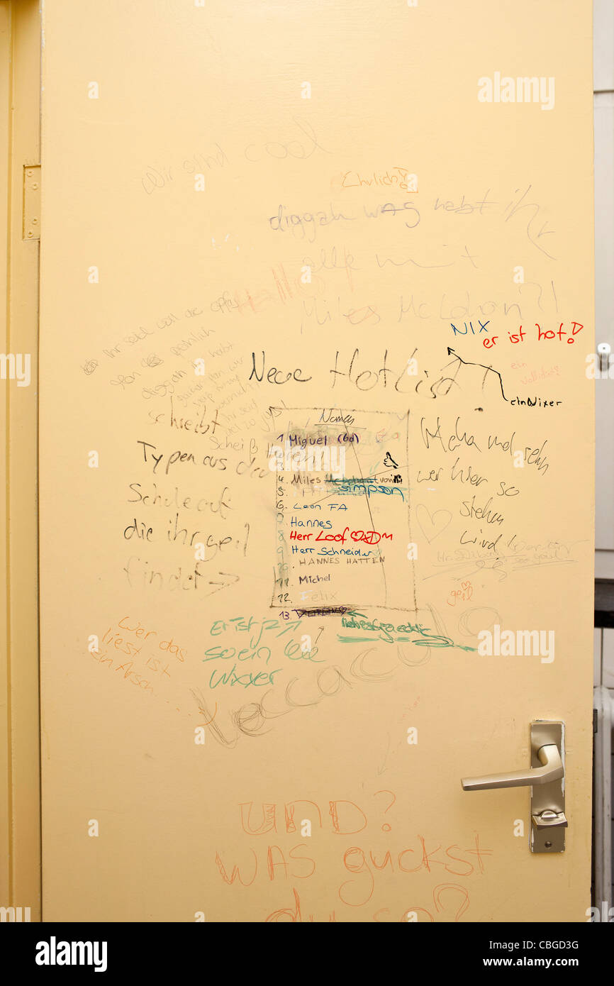Handwritten graffiti on bathroom door Stock Photo
