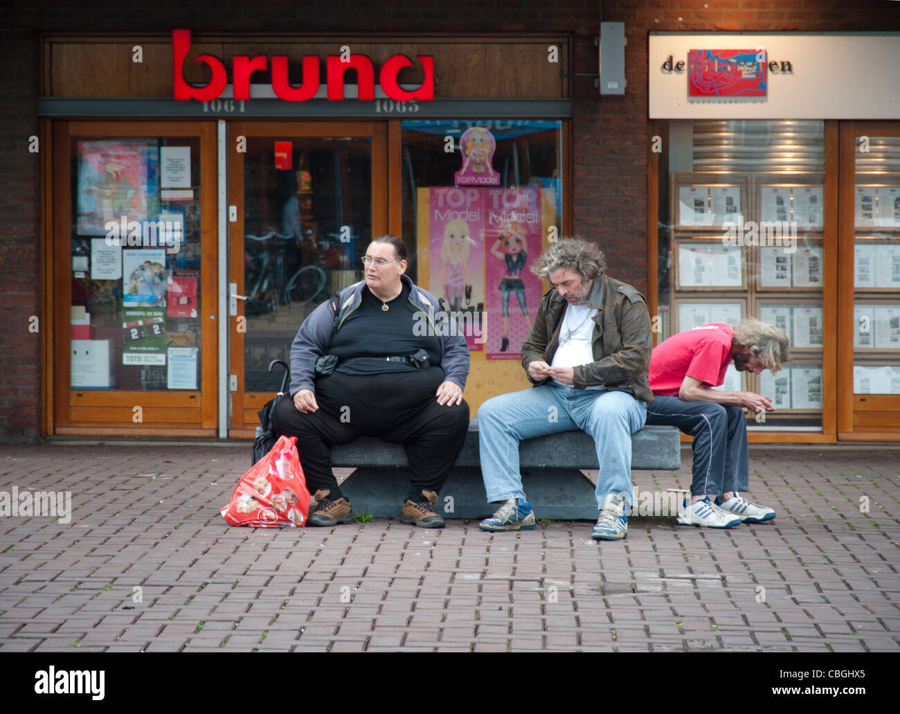 Men having a rest at, shopping mall, obesity, obese, homeless, Netherlands, Amsterdam, Bruna, Stock Photo