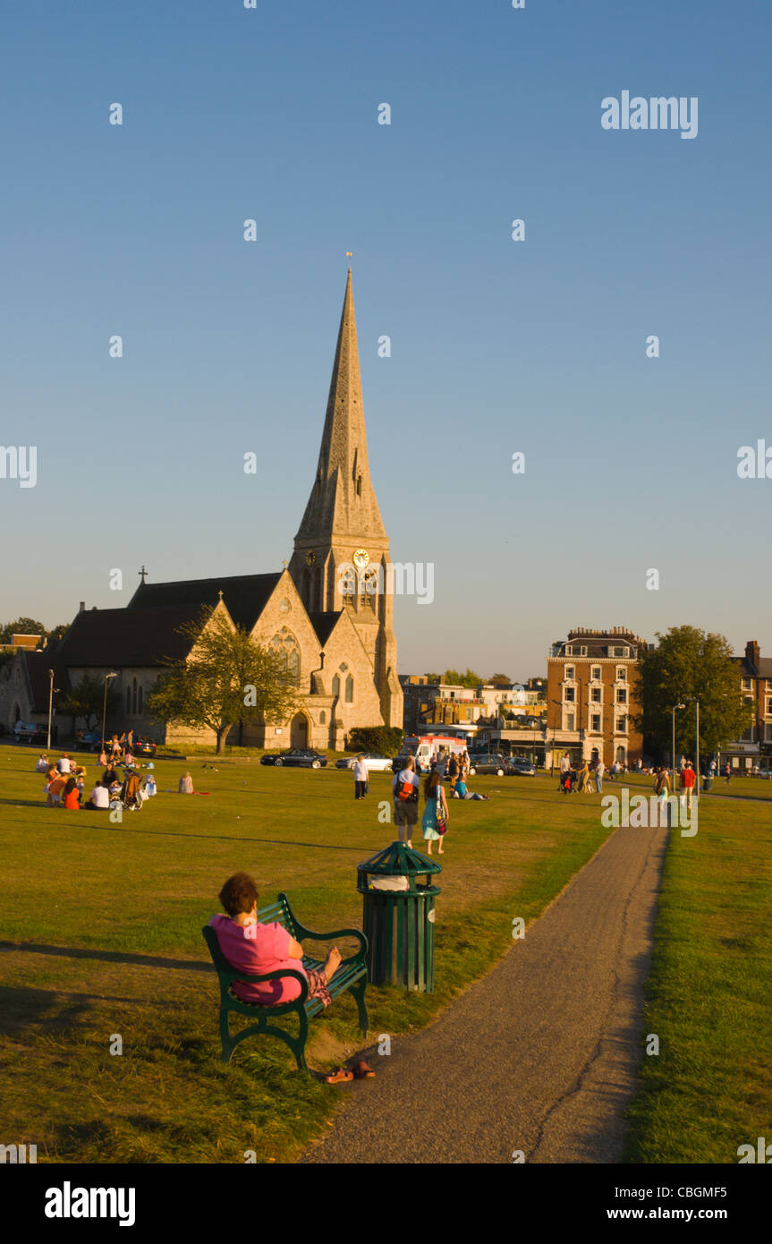 People in park with All Saints Church in background Blackheath south London England UK Europe Stock Photo