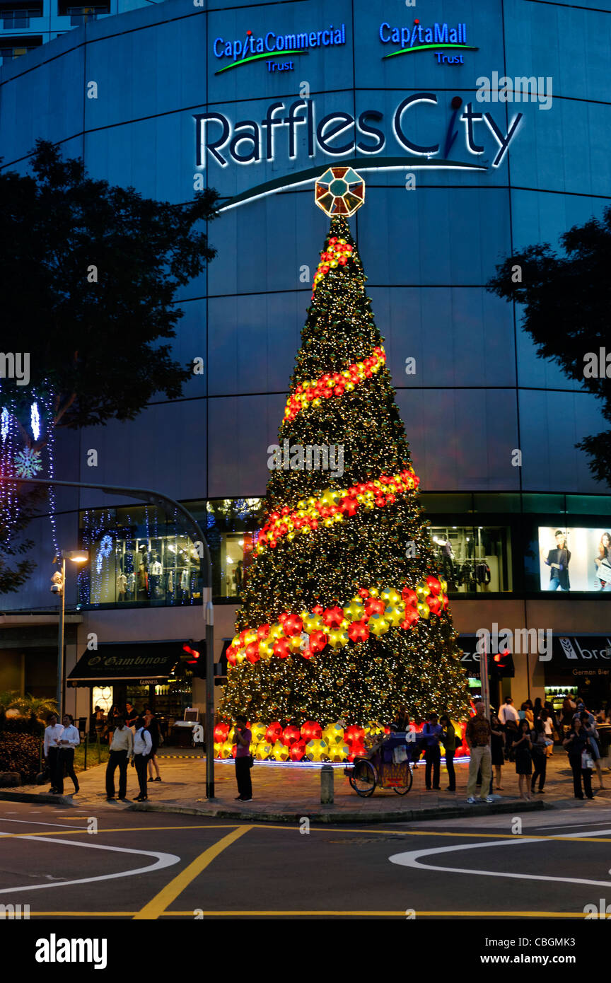 Large Christmas Tree outside Raffles City shopping mall in City Hall, Singapore. Stock Photo