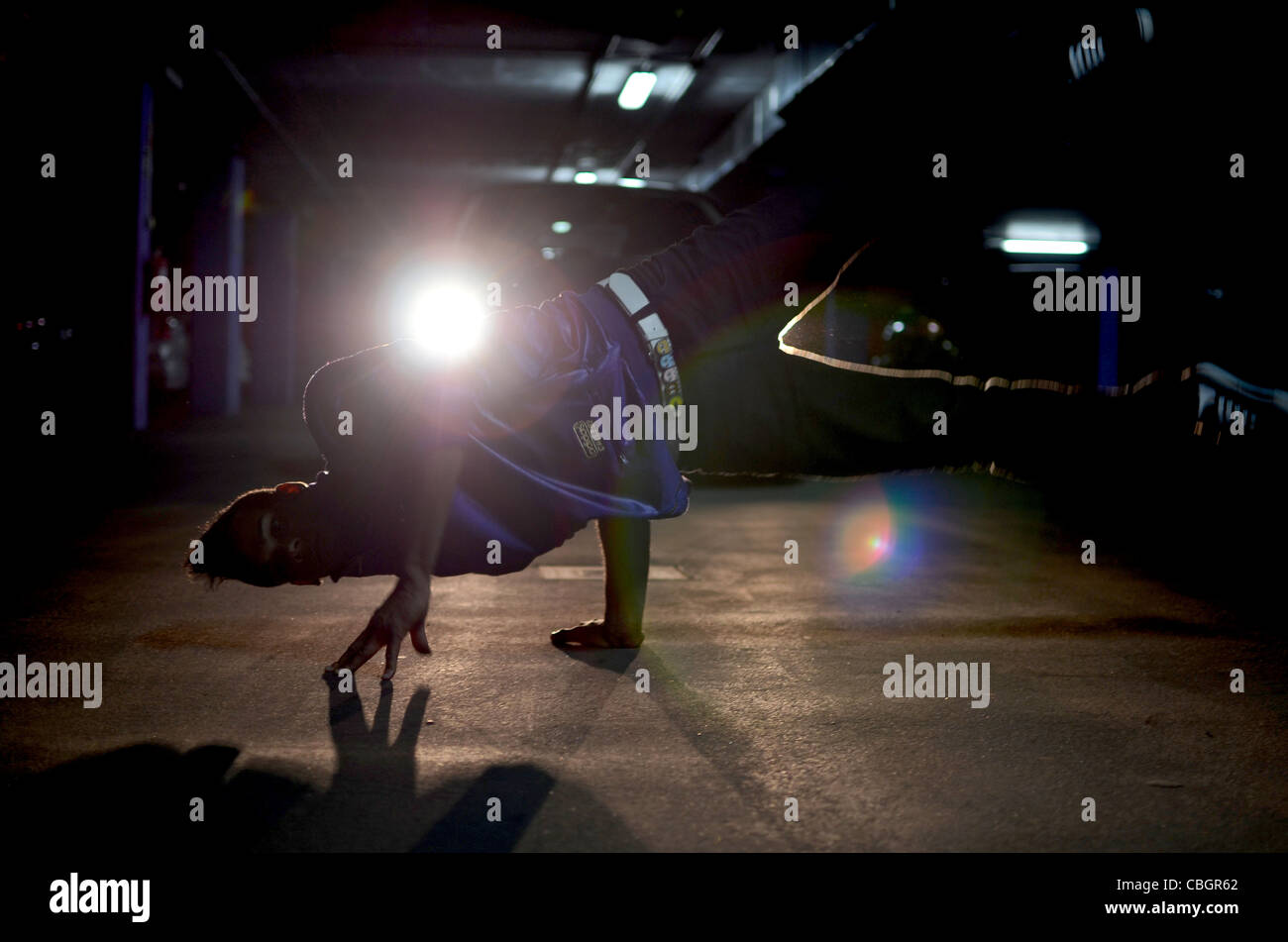 Breakdancer John Lartey performs in a garage Stock Photo