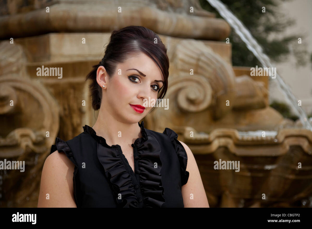 Portrait of young girl by a fountain Stock Photo - Alamy