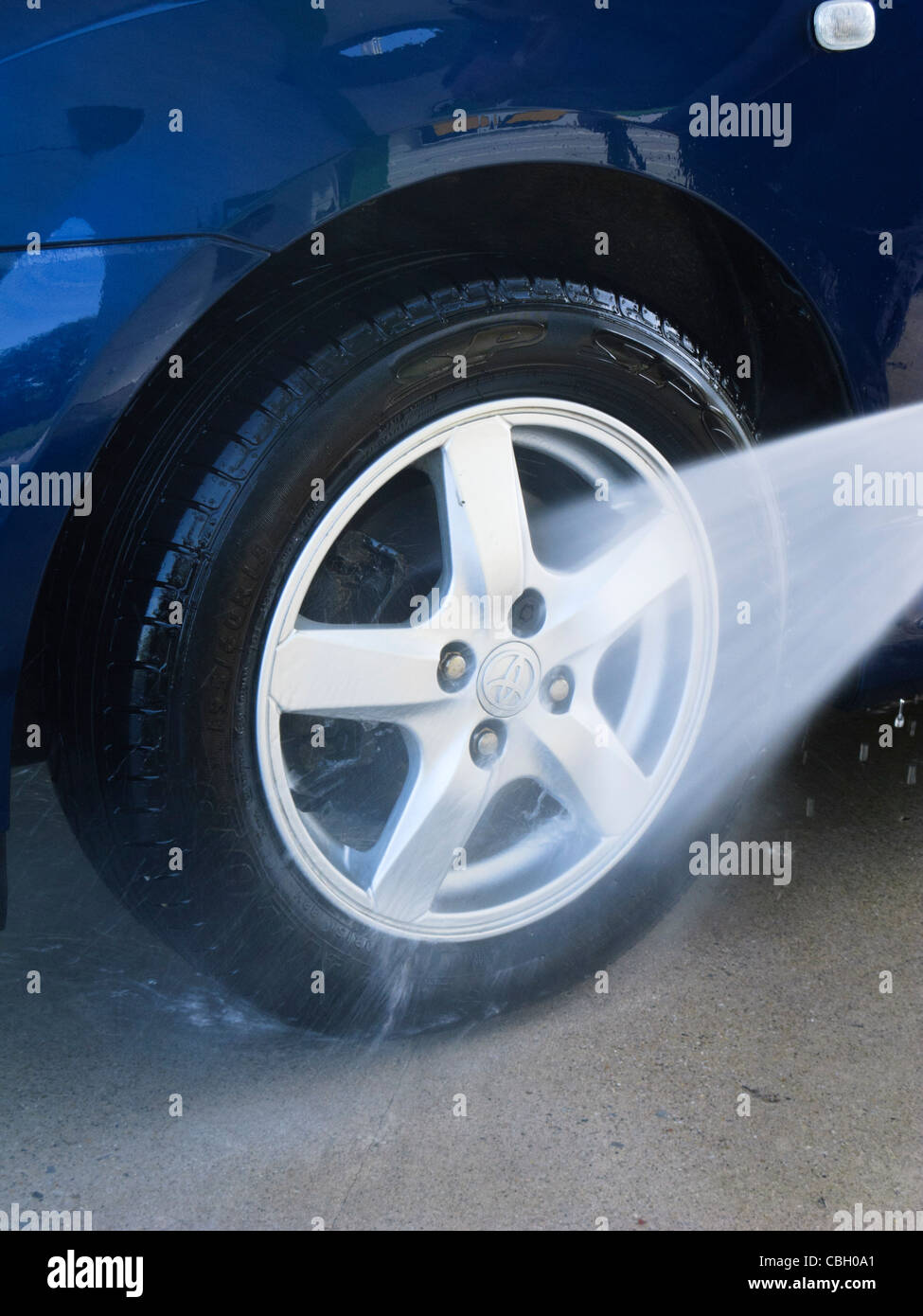 Spray washing car wheel at a jet wash Stock Photo