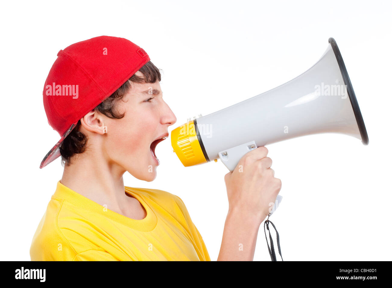 teenage boy in red baseball cap shouting in megaphone -isolated on white Stock Photo