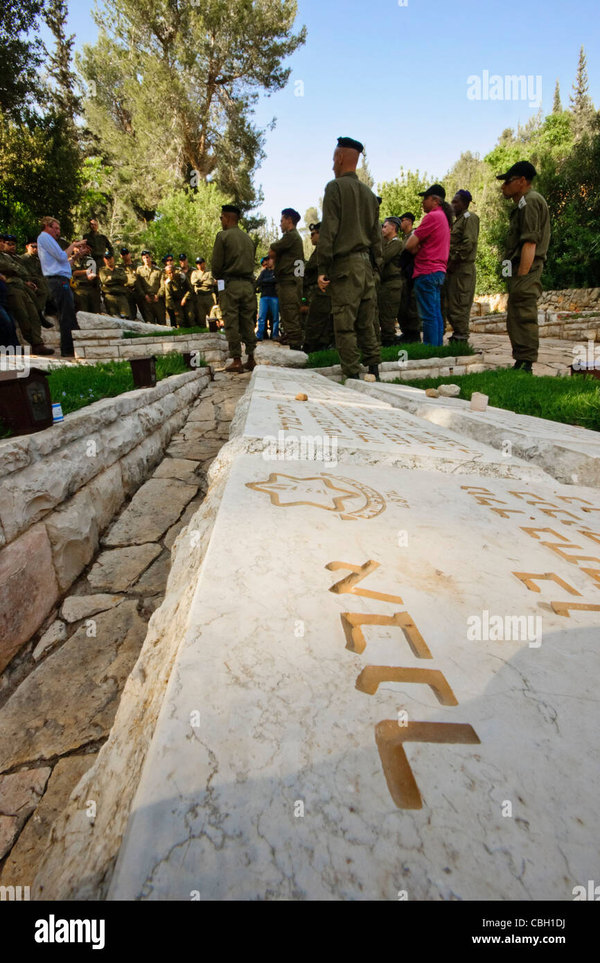 Israel. Graves in the 'Harel' military cemetery near Kiryat-Anavim. Soldiers in the background listen to a guide. Stock Photo