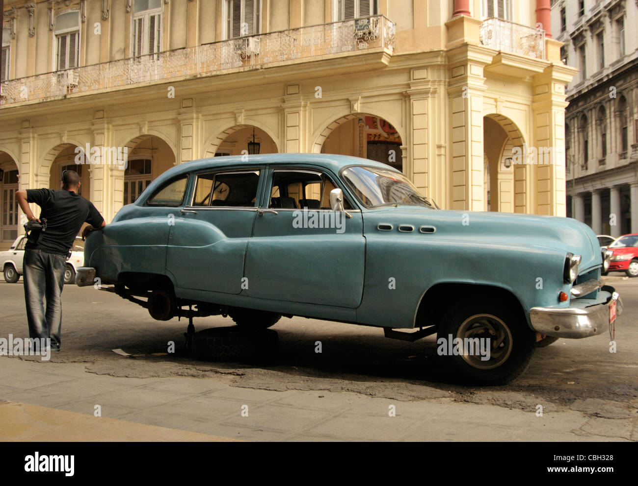 driver facing unexpected with his old '50 car in Havana town, Cuba Stock Photo