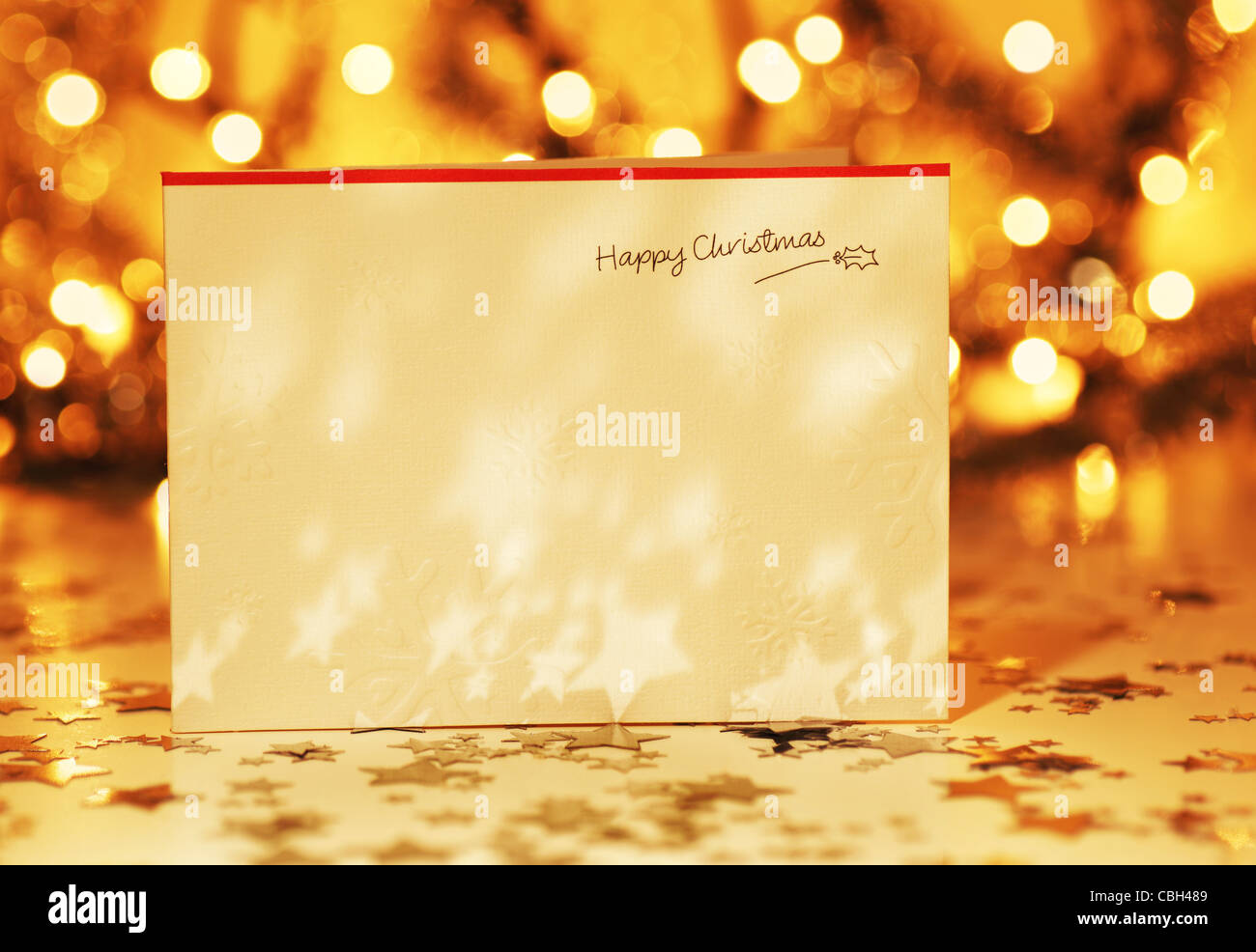 Beautiful gold happy Christmas card,winter holiday background, decoration postcard with stars over defocus lights Stock Photo