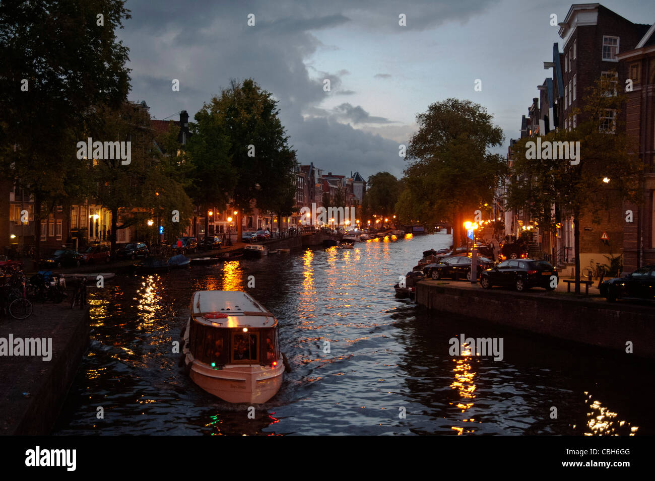 Amsterdam canal Prinsengracht at sunset with boat for tourist trip Stock Photo