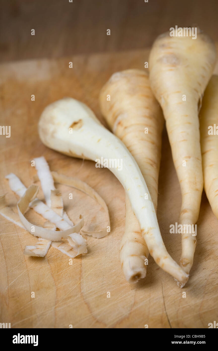 peeling parsnips preparing the root vegetables for cooking food Stock