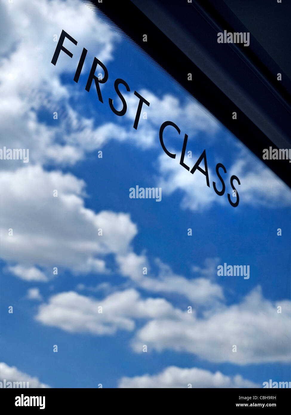 First Class Travel Sign on window of Pullman railway train carriage with infinity blue sky and clouds behind concept generic premier transportation Stock Photo