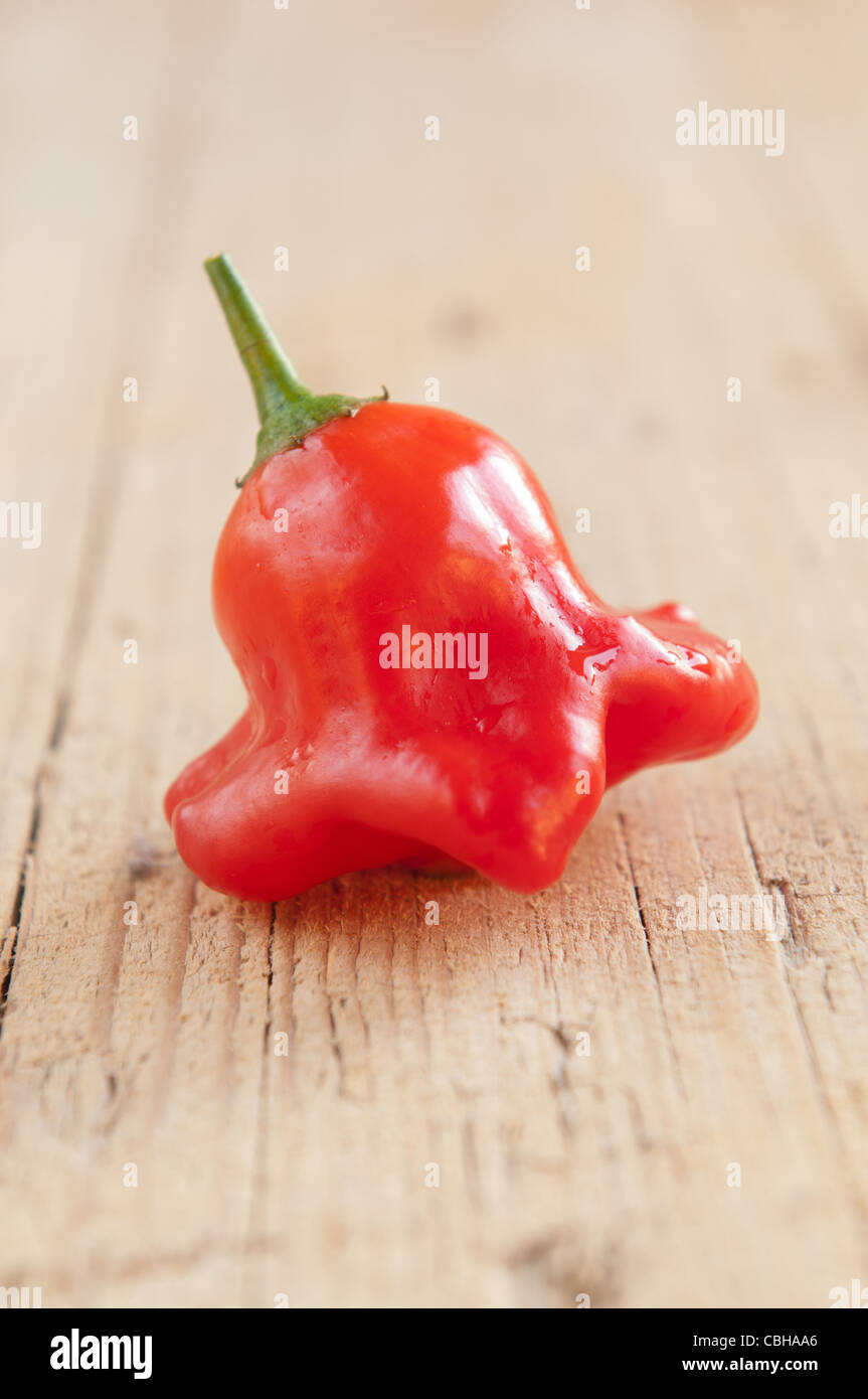 Red hot chili peppers on a rustic wooden background Stock Photo - Alamy