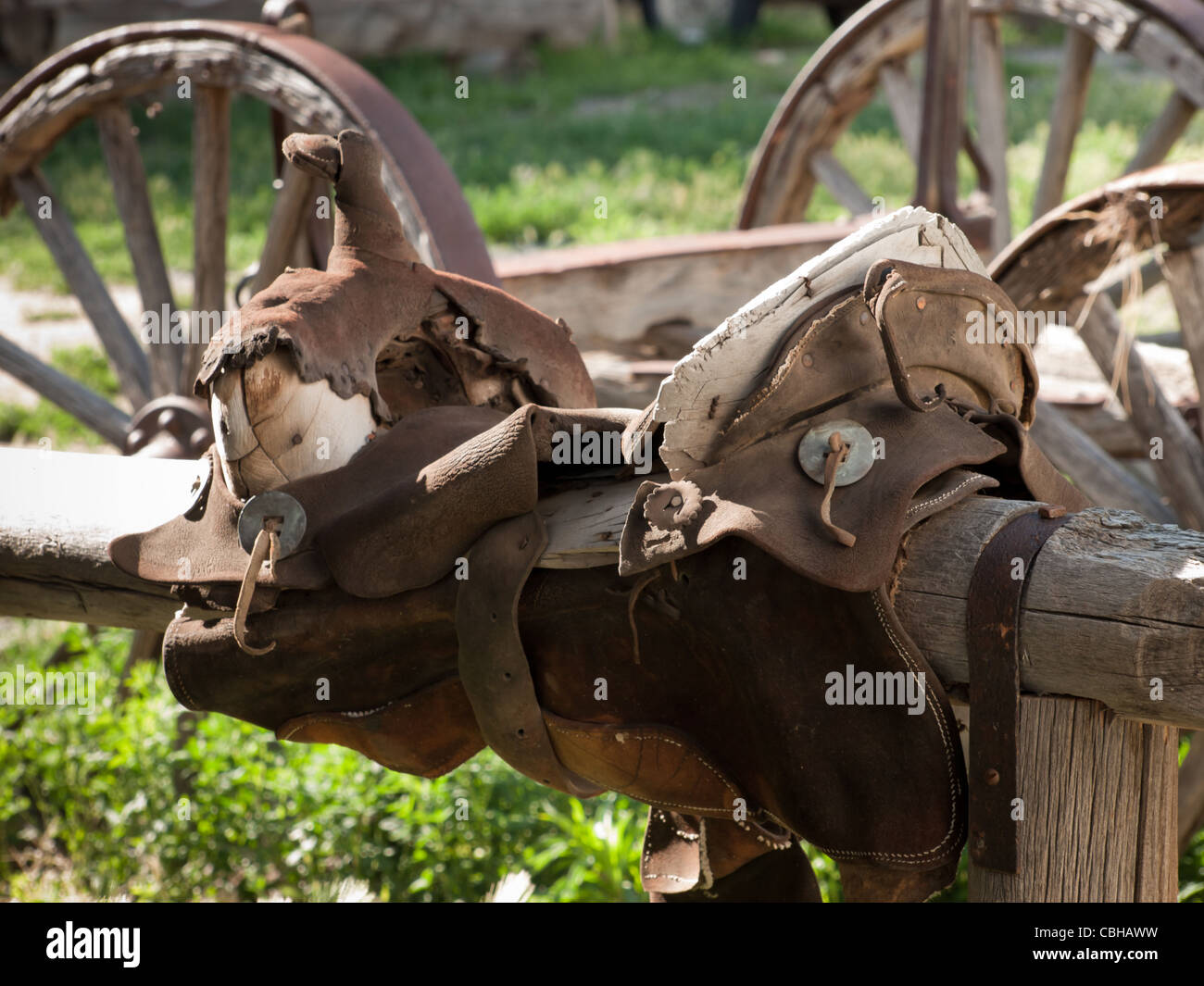 Old horse saddle on wooden fence. Museum of the Mountain West in