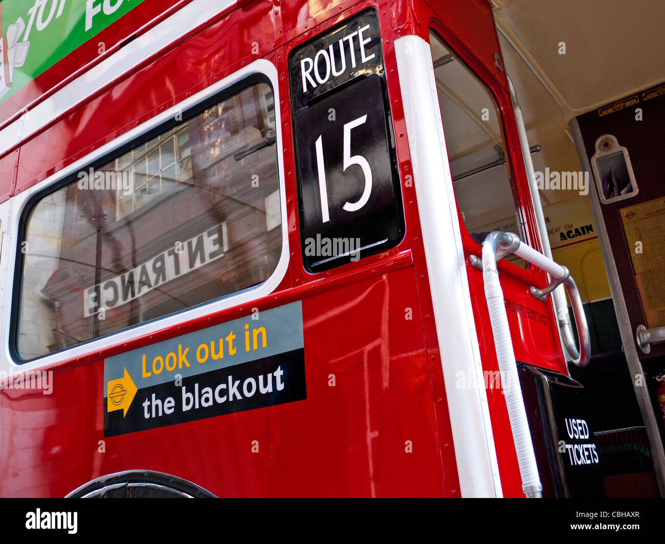 Restored historic traditional red London bus with WW2 poster 'Look out in the Blackout' Stock Photo