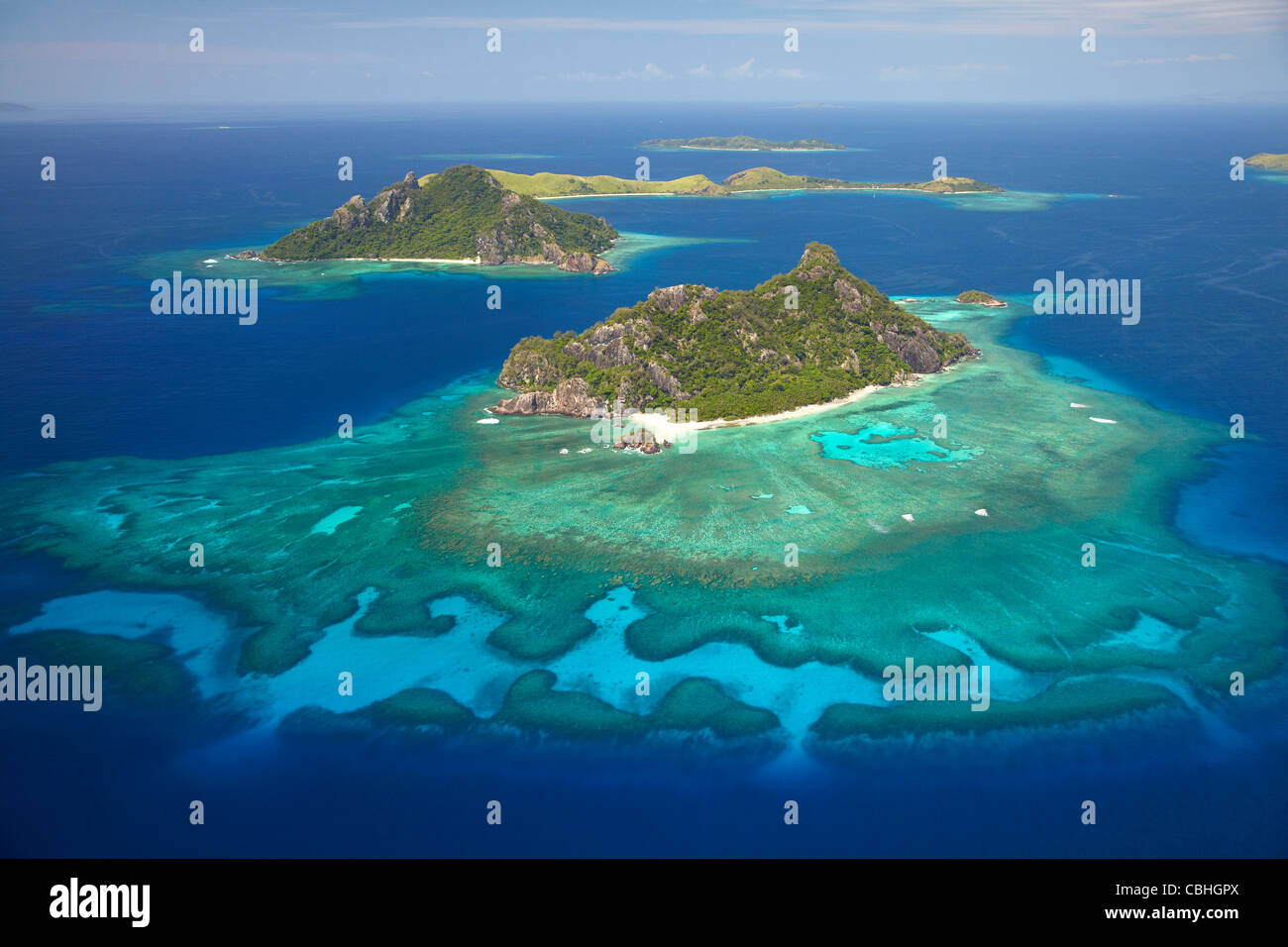 Monuriki Island and coral reef, Mamanuca Islands, Fiji, South Pacific - aerial Stock Photo