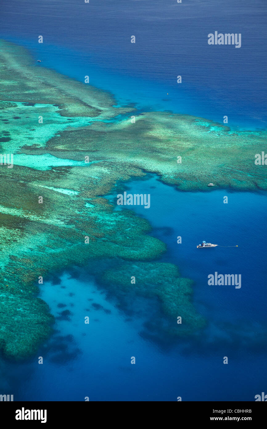 Coral reef and boat beside Tokoriki Island, Mamanuca Islands, Fiji ...