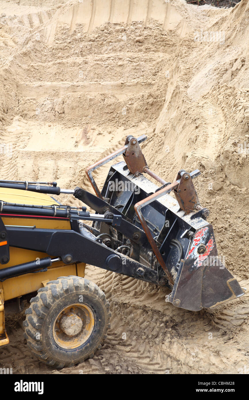 Yellow excavator on the construction site Stock Photo - Alamy