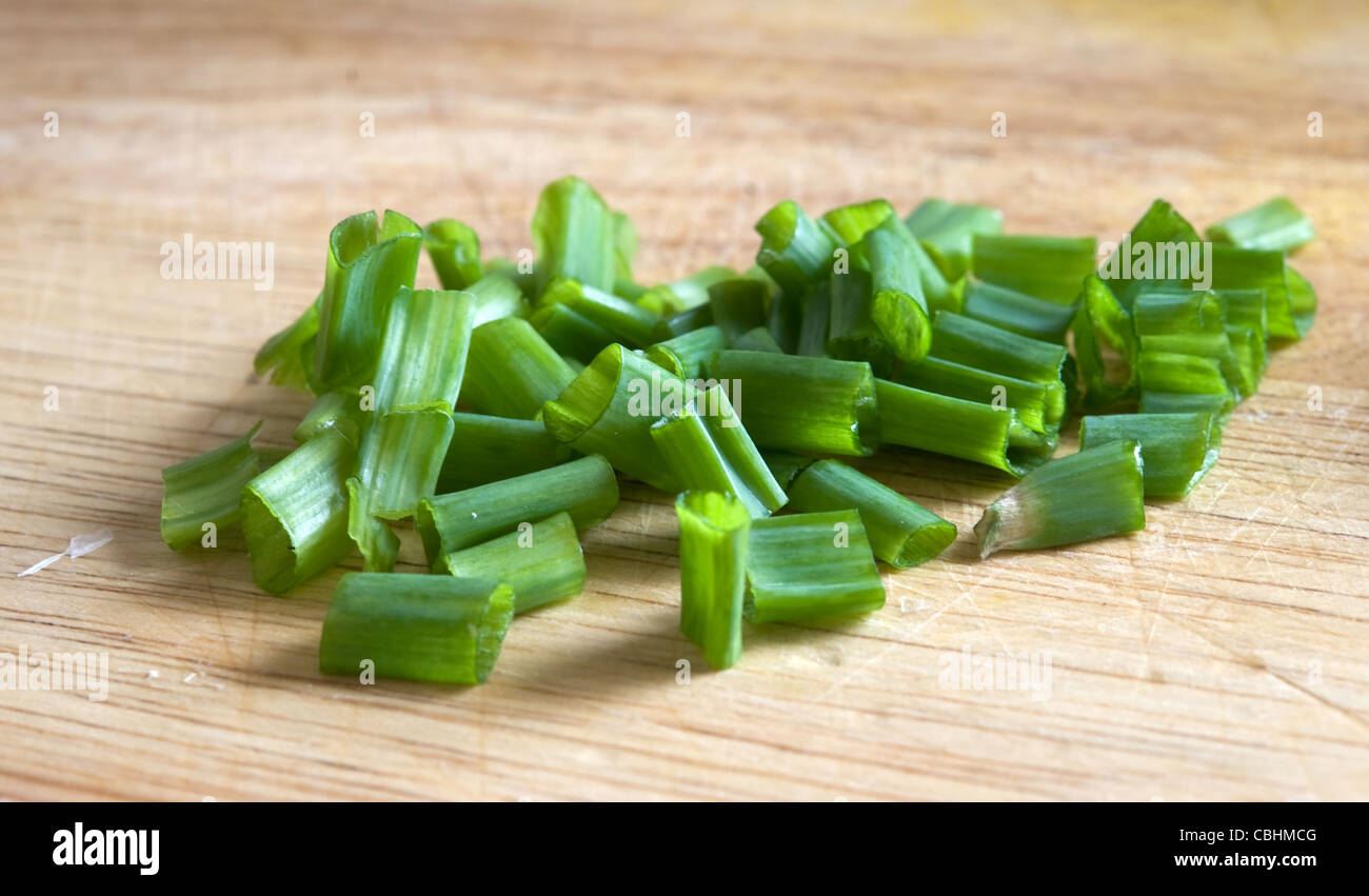 a chopped green onions on wooden board Stock Photo - Alamy