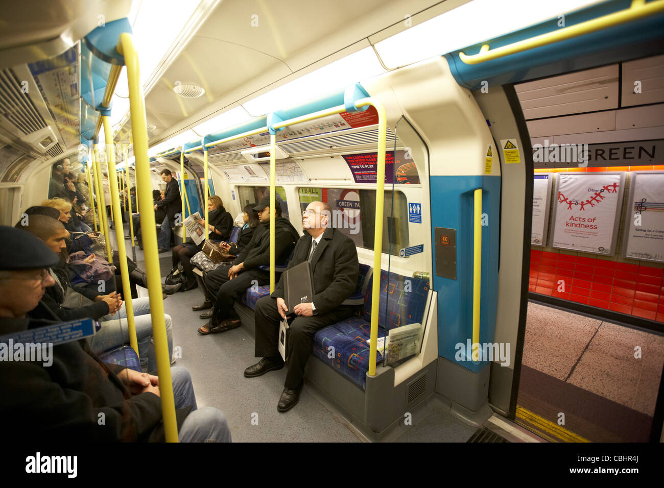 passengers on london underground tube train with doors open england