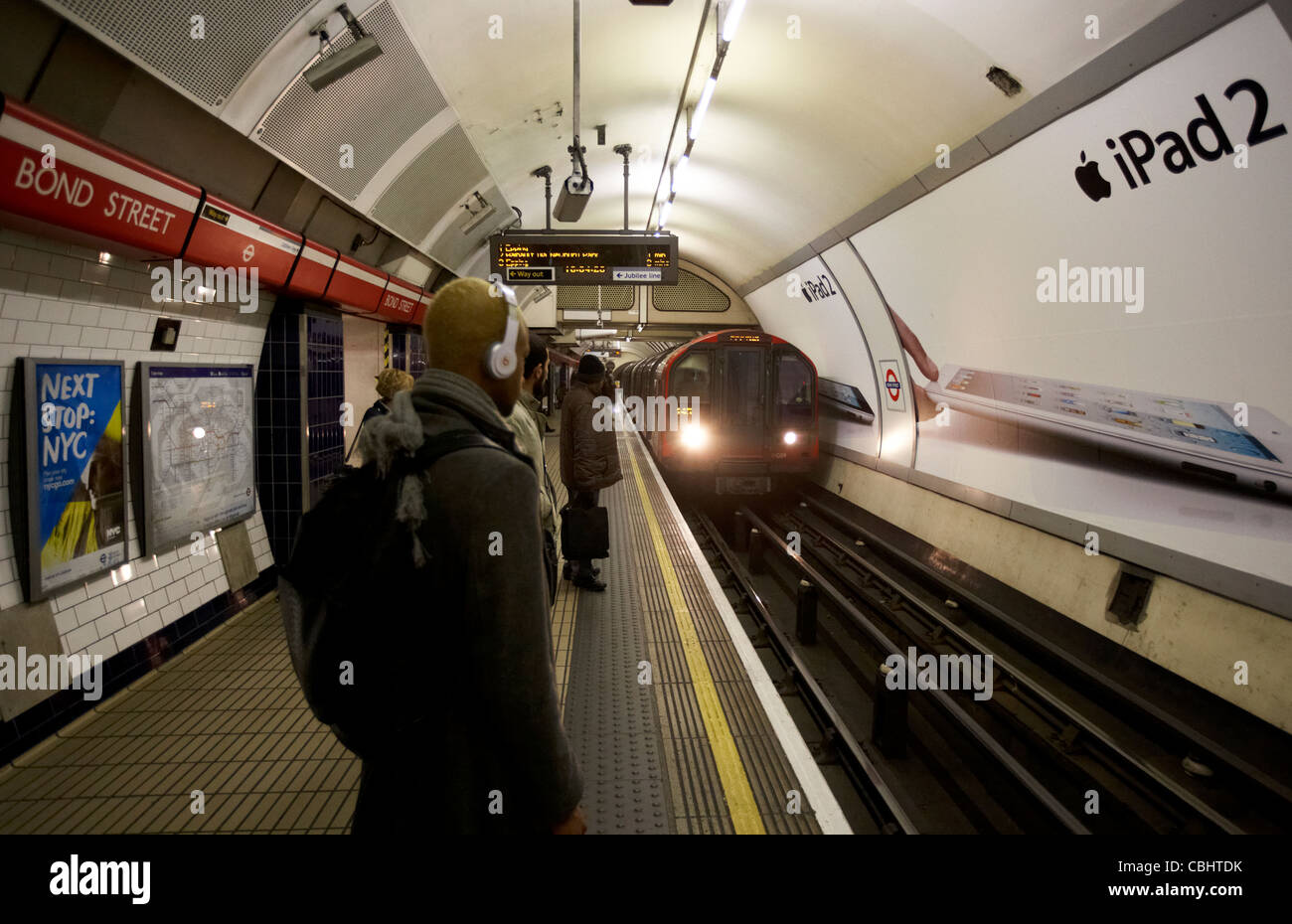 london underground train arriving in bond street station with passengers waiting england united kingdom uk Stock Photo