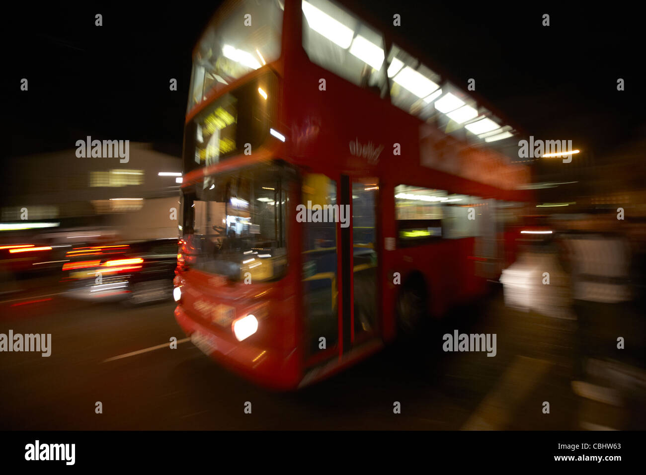 london red double decker bus public transport at night england united kingdom uk deliberate motion blur panned Stock Photo