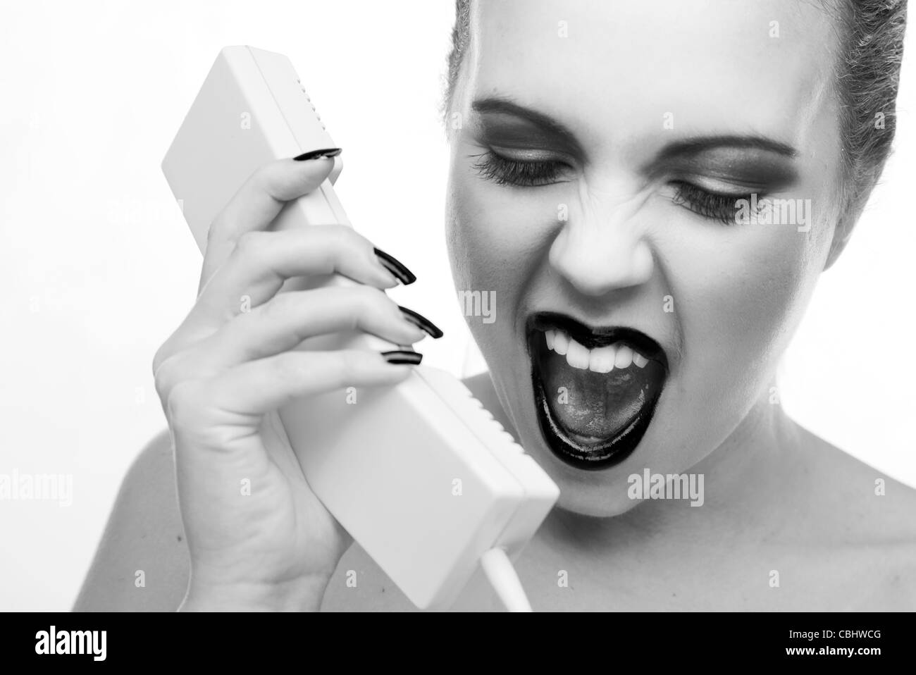 woman very angry shouting down the phone at somebody Stock Photo