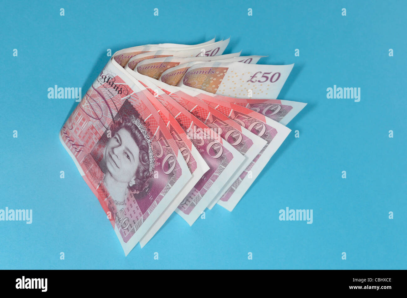 Debt Crisis. Savings and falling value of currencies. Chevron row of fifty pound bank notes as the debt crisis takes hold. Stock Photo
