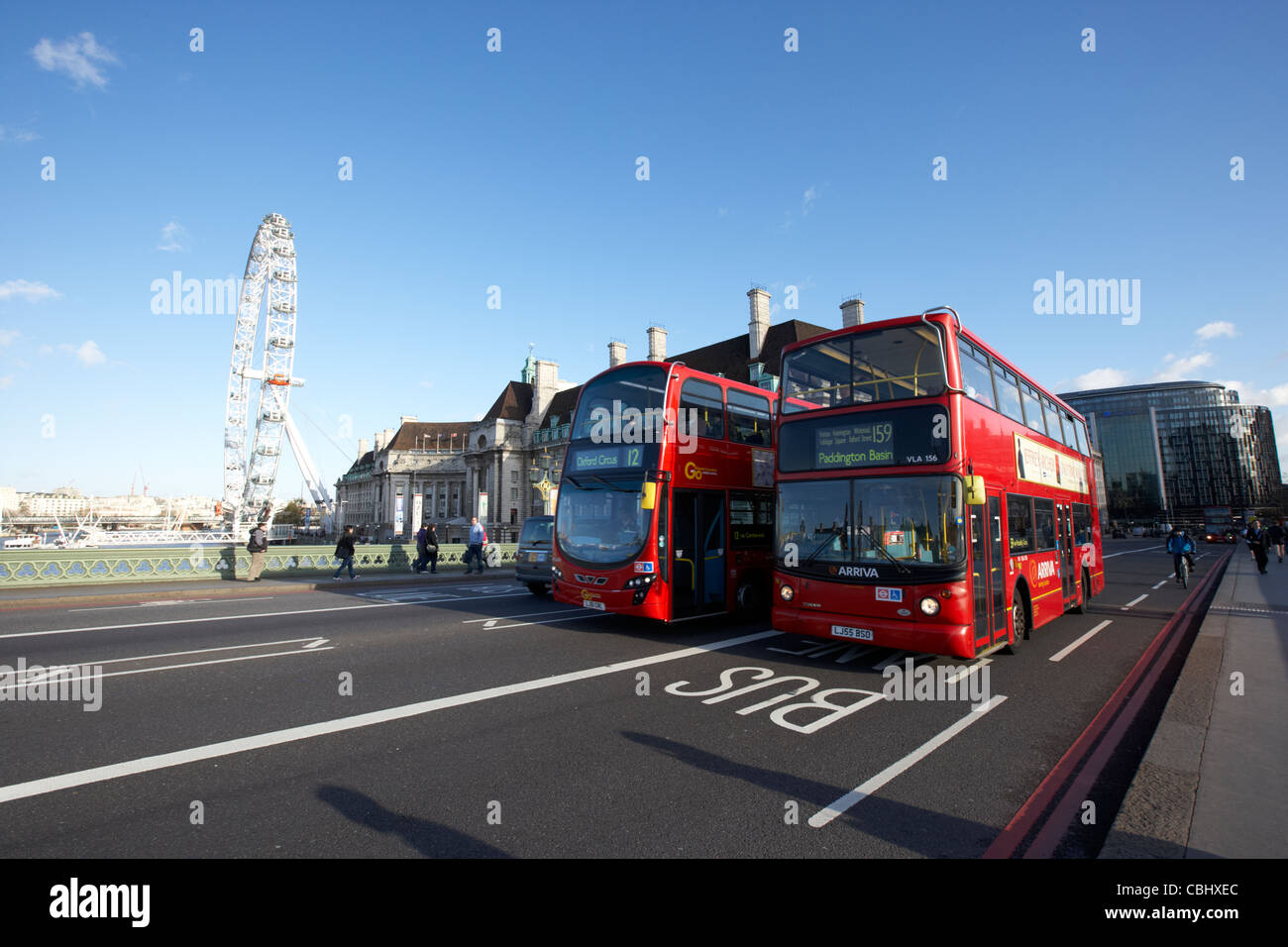 two london red double decker busses public transport crossing westminster bridge england united kingdom uk Stock Photo