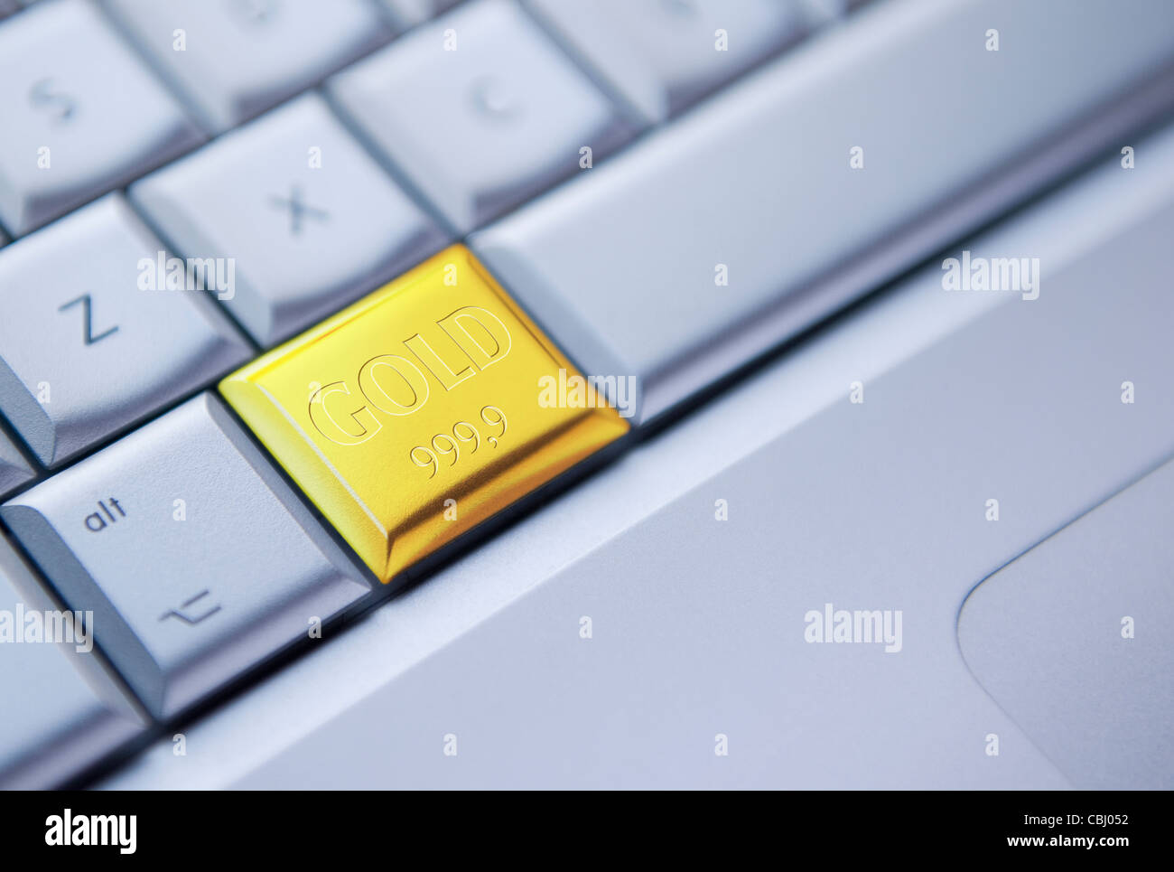Buying Gold Online. Concept image of keyboard with one key depicted as a gold bar Stock Photo