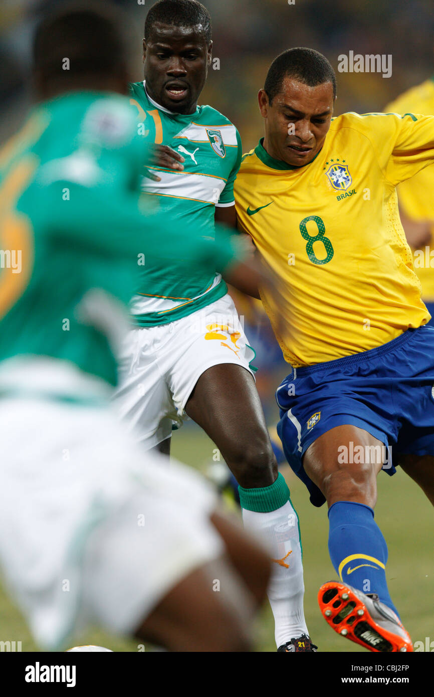 Emmanuel Eboue of Côte d'Ivoire (L) battles against Gilberto Silva of Brazil (R) during a 2010 FIFA World Cup match. Stock Photo