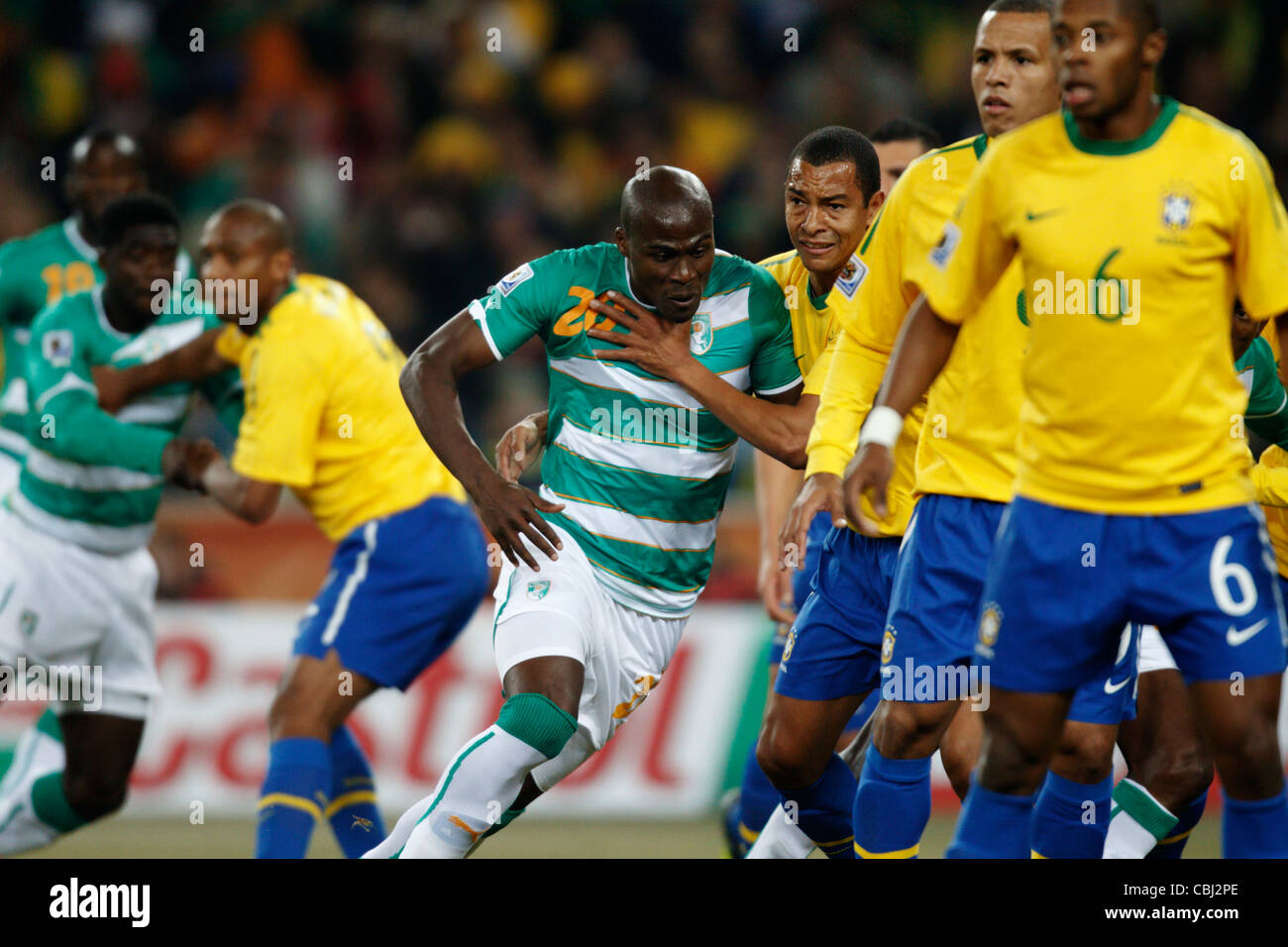 Guy Demel of Côte d'Ivoire (L) fights for position against Gilberto Silva of Brazil (R) during a 2010 FIFA World Cup match. Stock Photo