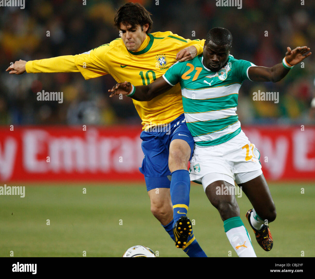 Kaka of Brazil (L) battles against Emmanuel Eboue of Côte d'Ivoire (R) during a  FIFA World Cup match June 20, 2011. Stock Photo