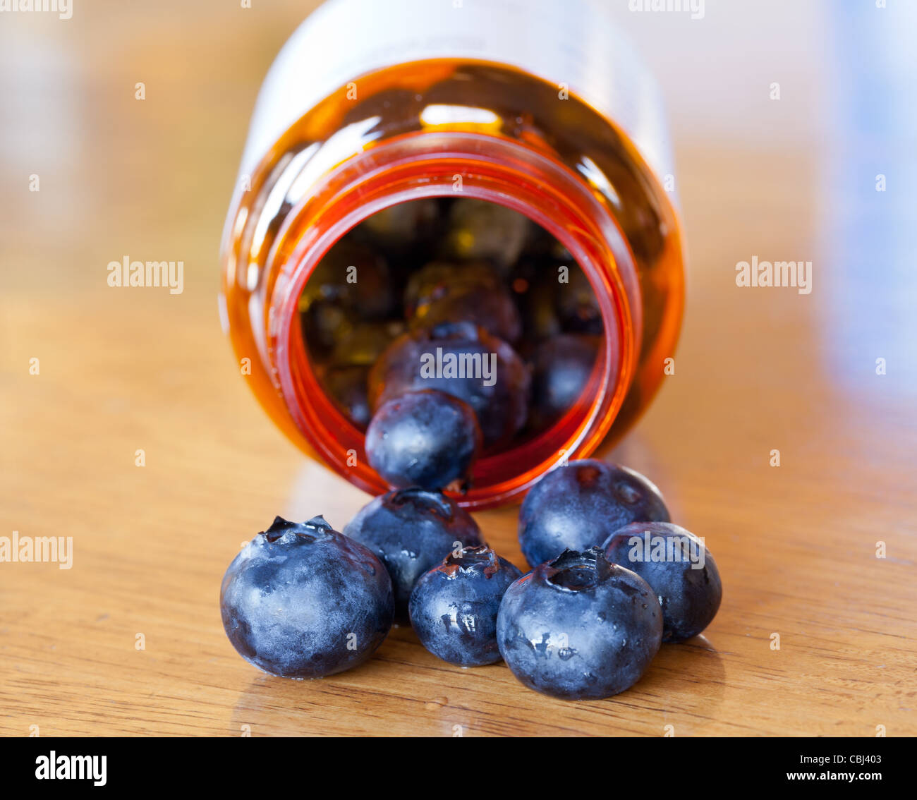 Fresh blueberries being poured from a prescription bottle Stock Photo