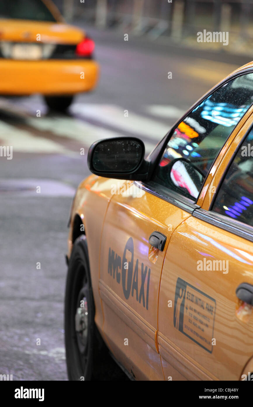 iconic New York City, yellow cab, close-up with reflections of lights on Broadway, Manhattan, NYC, USA Stock Photo