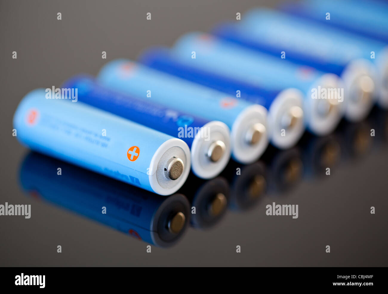 AA size NiMH batteries in a row with focus on the first one Stock Photo