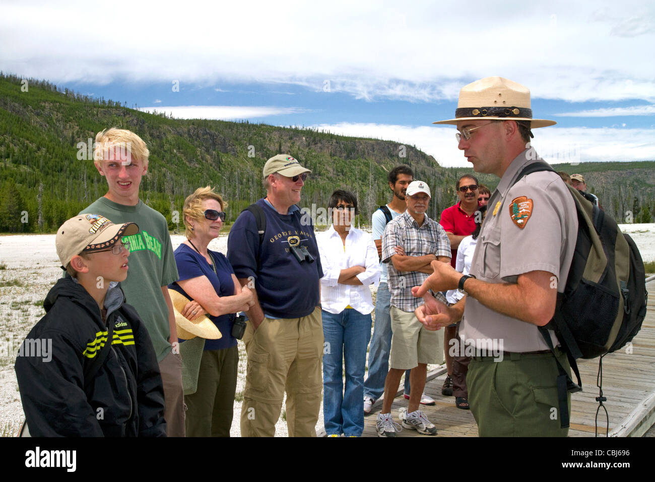 Park ranger giving a tour group information about the Upper Geyser Basin in Yellowstone National Park, Wyoming, USA. Stock Photo