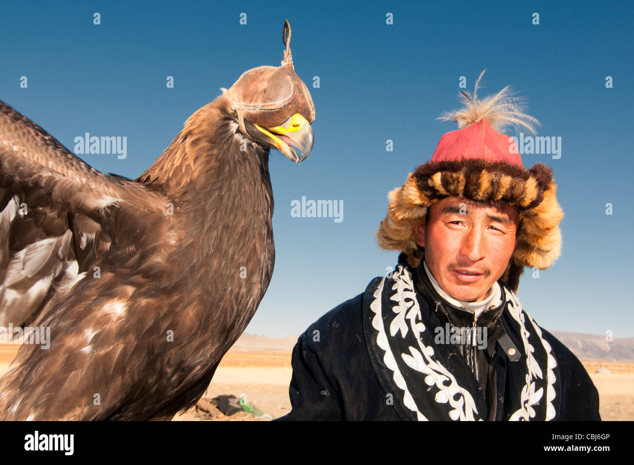 Kazakh eagle hunter and his golden eagle in the Altai Region of Bayan