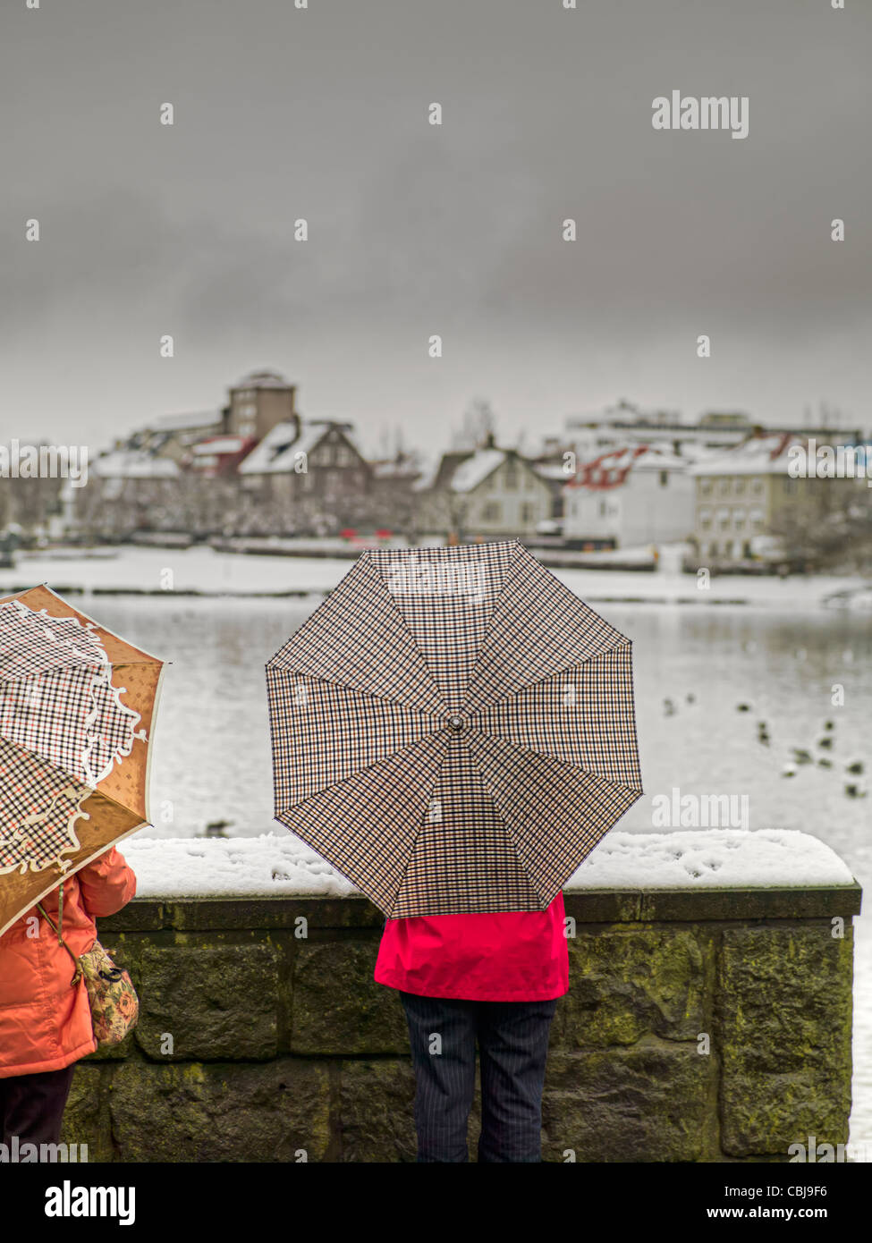 Using on umbrella on snowy day, Reykjavik, Iceland Stock Photo