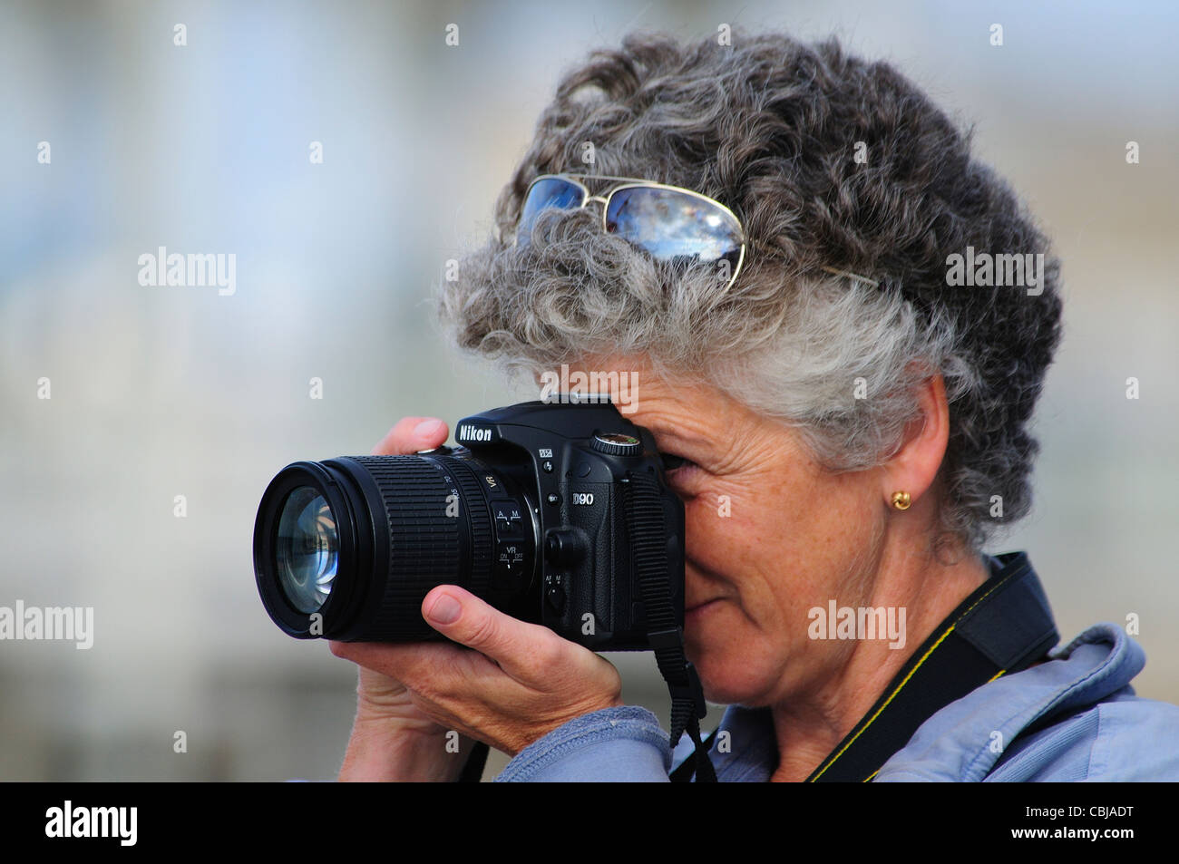 Lady photographer with her camera to her eye Stock Photo - Alamy
