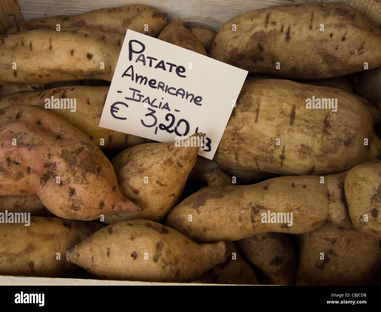 Sweet Potatoes in the market, Courmayeur, Italy, note that the Italian name, Patate Americane, means 'American Potatoes. Stock Photo