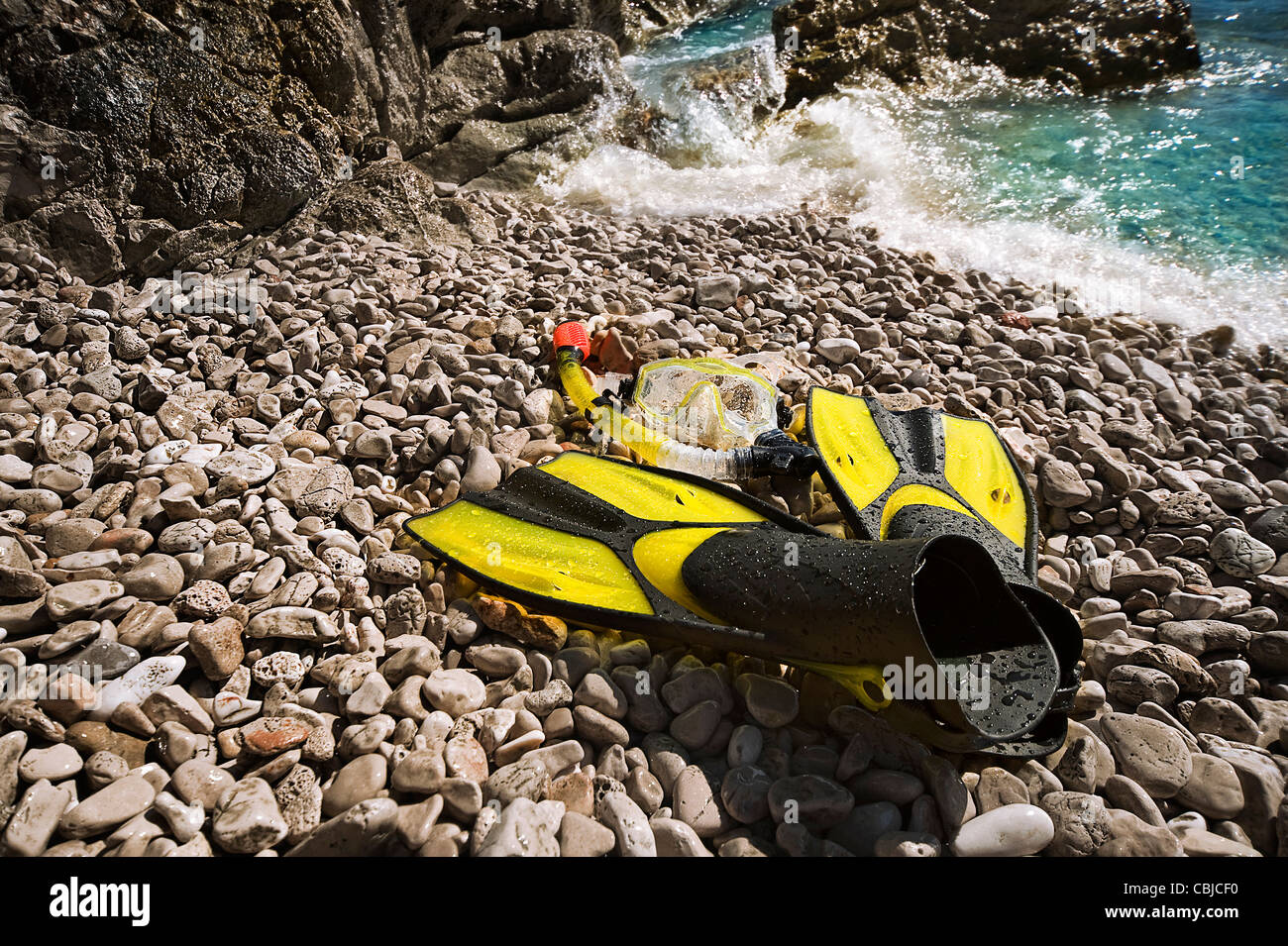 snorkeling equipment on a rocky beach Stock Photo