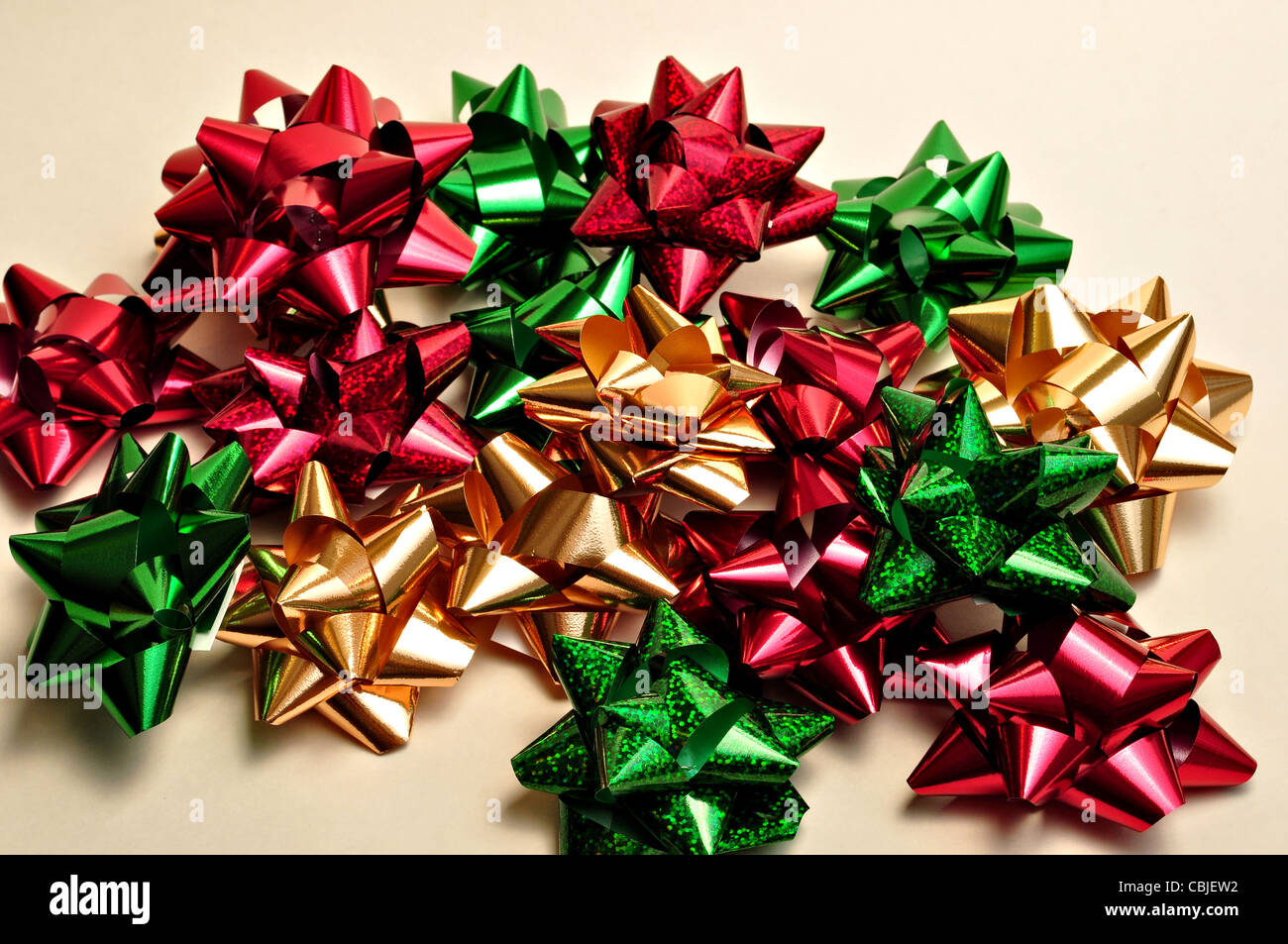 A bunch of Christmas bows lay on a white background. Stock Photo