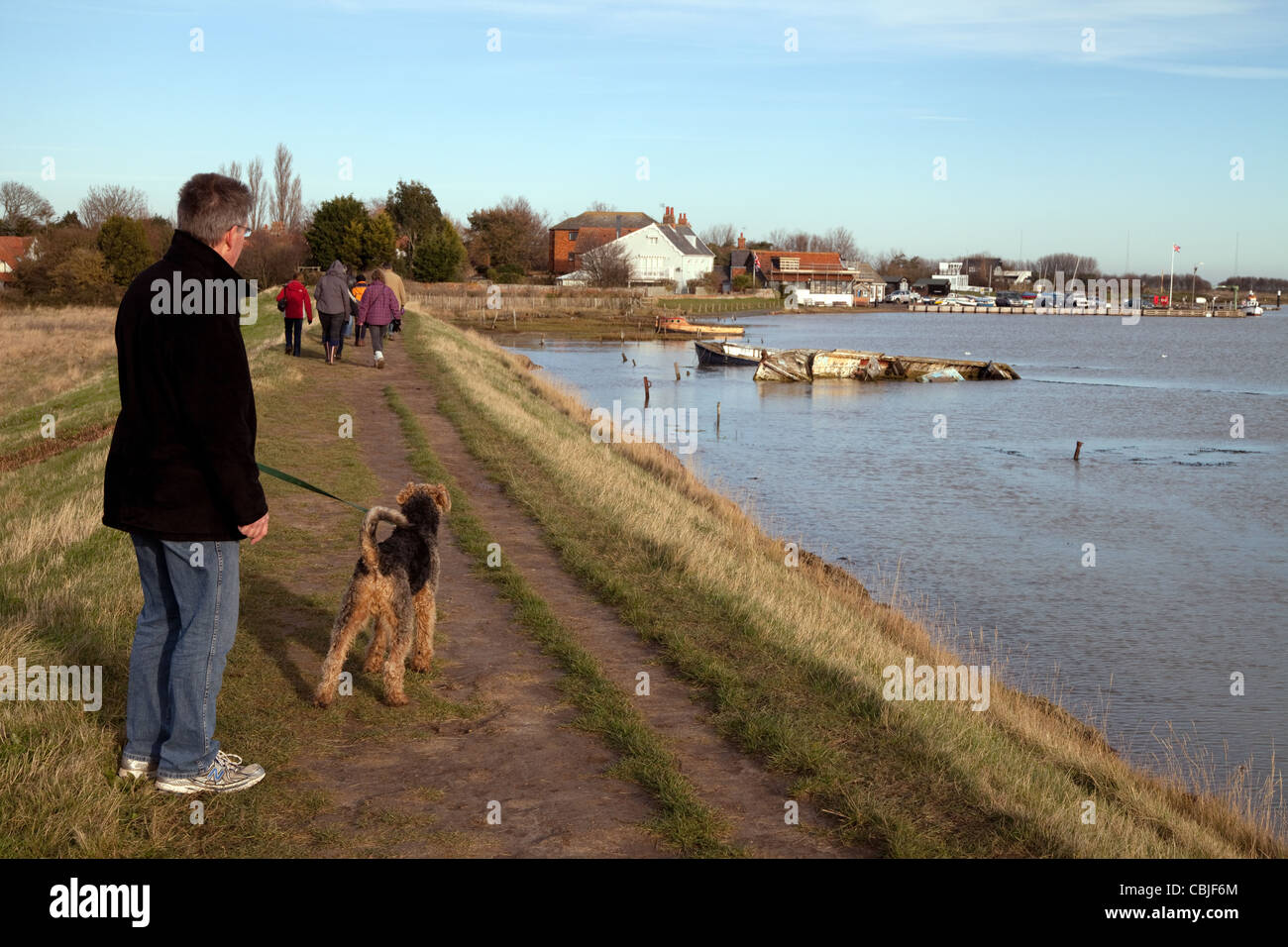 Walking the dog on the Suffolk Coast Path at Orford village, Suffolk countryside UK Stock Photo