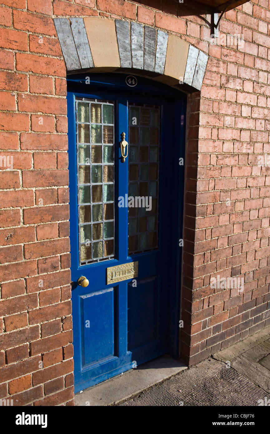 Blue front door No 44 of period terraced house in Kington Herefordshire England UK Stock Photo