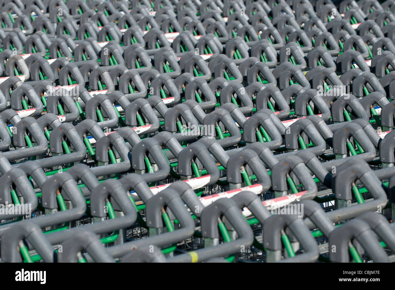 Rows of passenger trolleys or carts stand unused at Manchester Airport, UK. Stock Photo