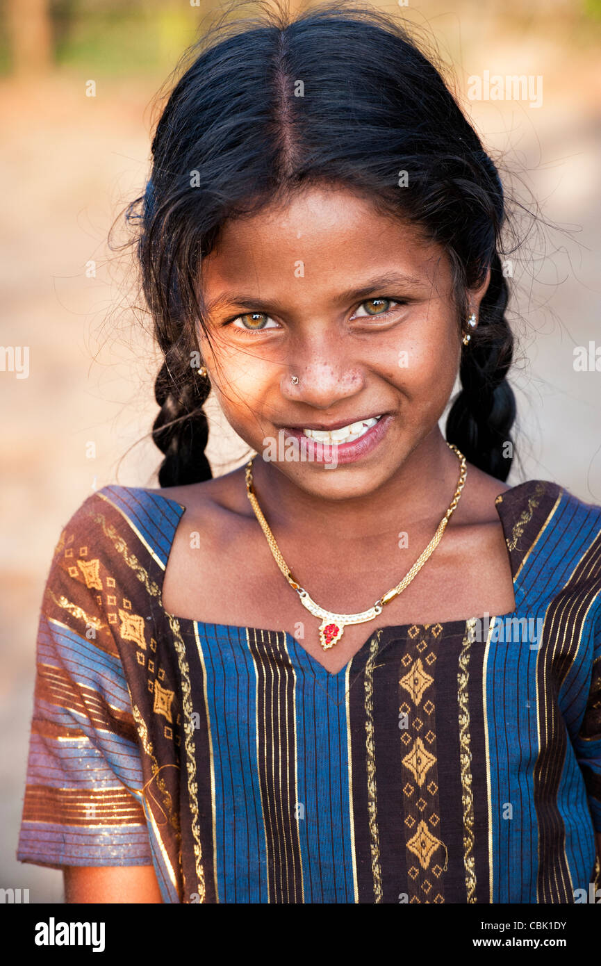 Happy young rural Indian village girl in afternoon sunlight. Andhra