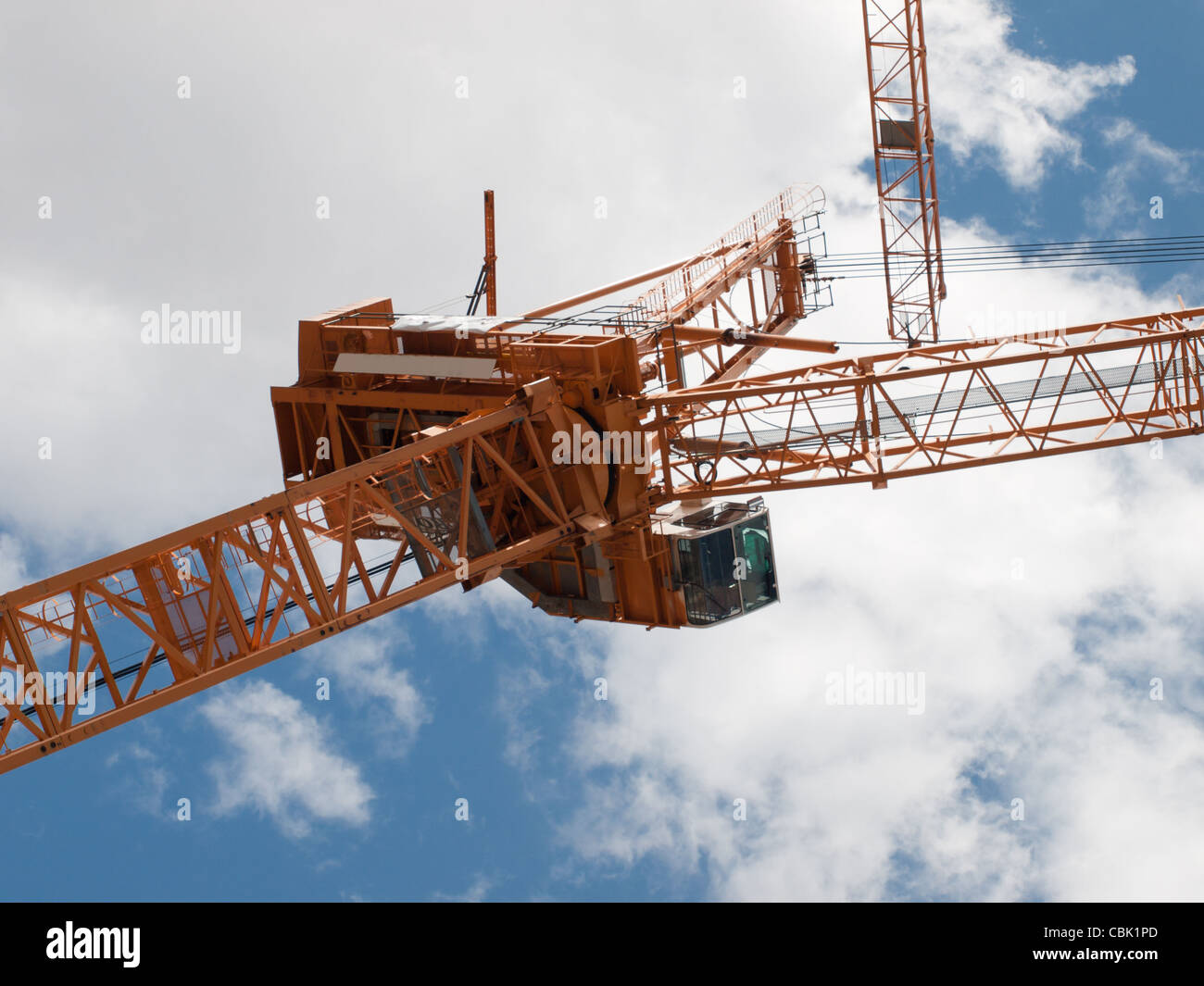 Yellow construction crane agains cloudy sky Stock Photo - Alamy
