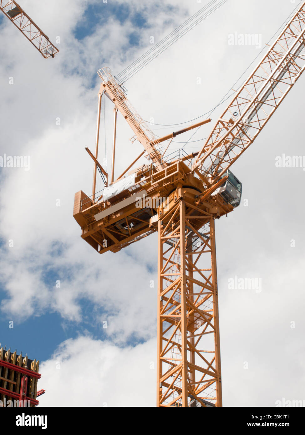 Yellow construction crane agains cloudy sky Stock Photo - Alamy