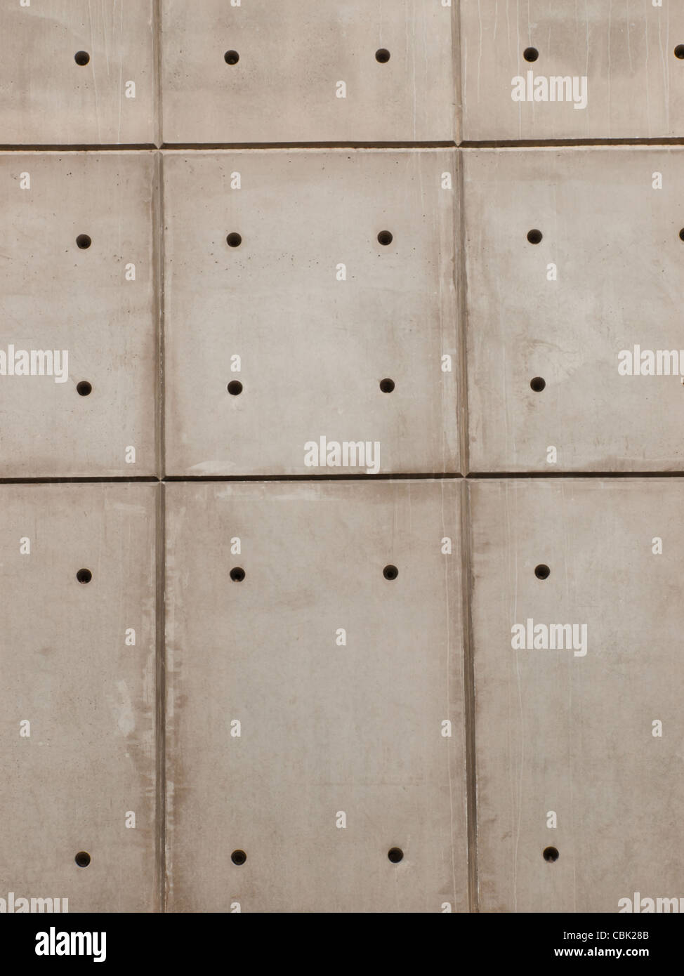 Raw concrete wall background with formwork lines and tie hole plugs