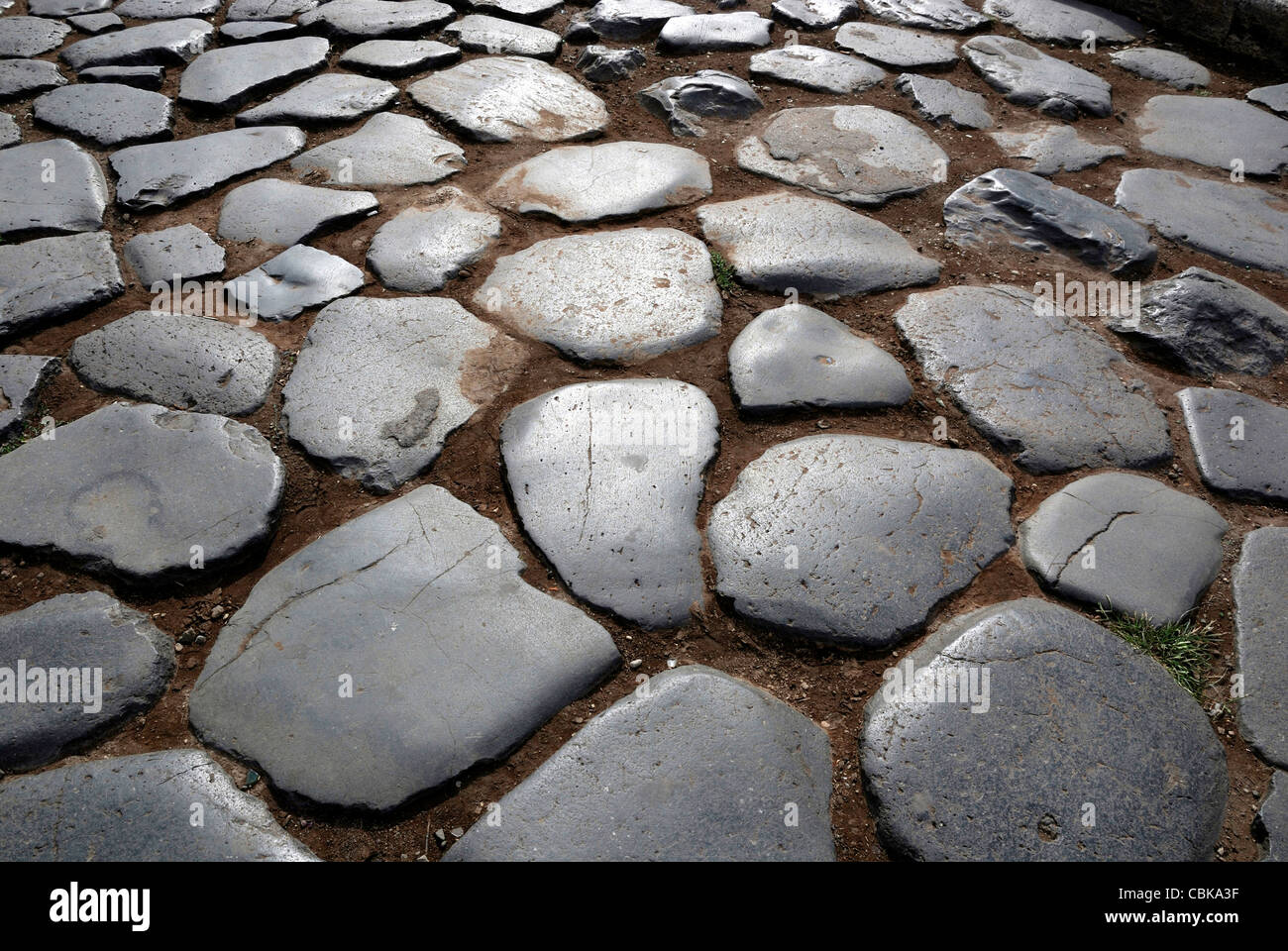 Ancient cobblestones at the Colosseum in Rome. Stock Photo