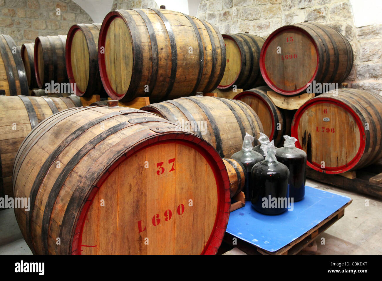 Oak Barrels in the cellars of Cremisan Winery in Beit Jala near Bethlehem, Palestine, West Bank Stock Photo